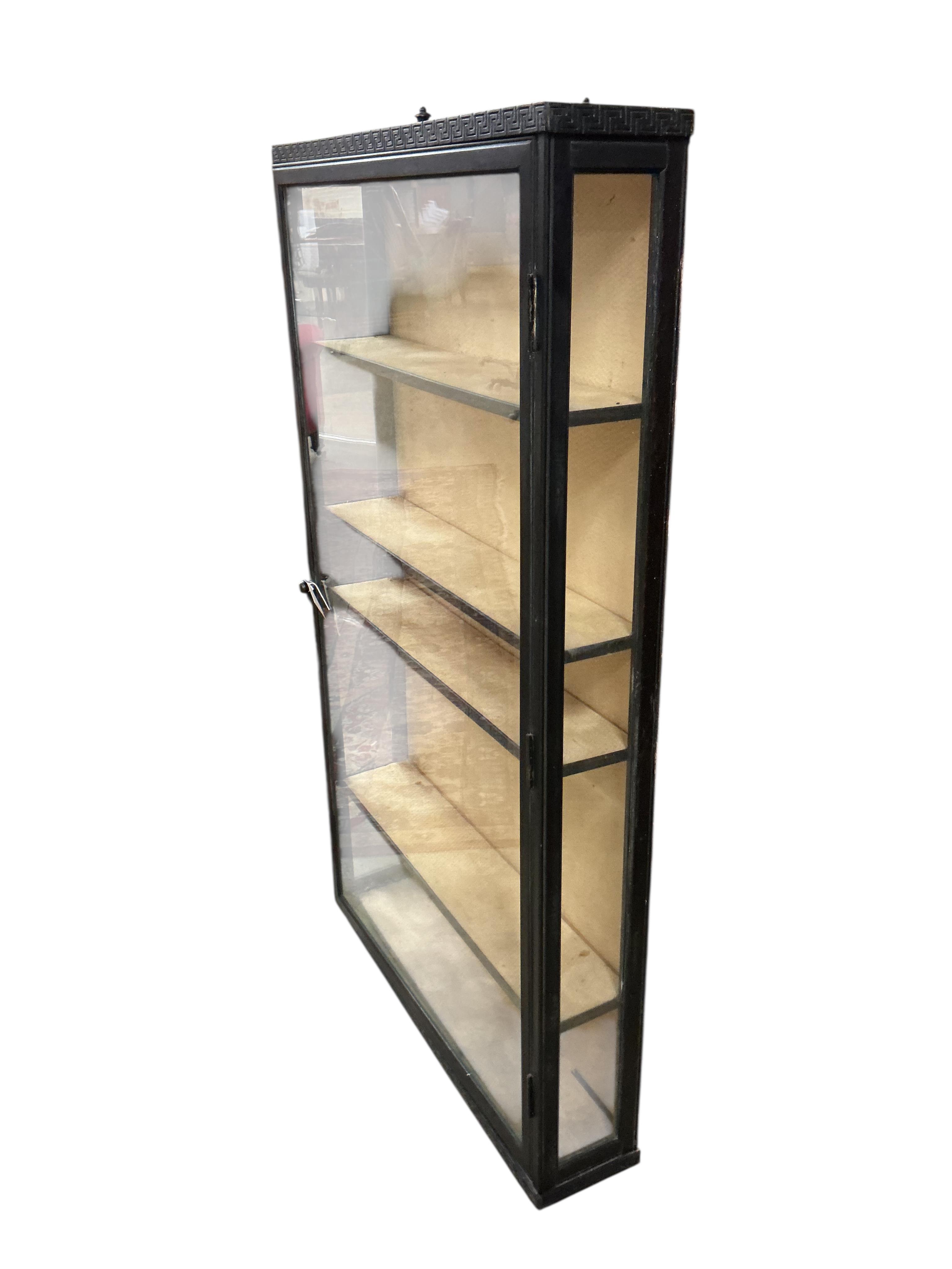 A Regency style ebonised wall cabinet, width 70cm, depth 15cm, height 122cm